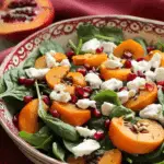Spinach and Persimmon Salad with Goat Cheese and Pomegranate