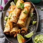 Crispy Chicken Tinga Taquitos with Lime Avocado Crema